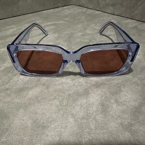Stylish DL (Dan Levy) Eyewear “Walker” sunglasses in translucent blue gray frame
